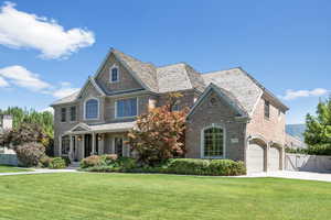 View of front of home featuring a garage and a front lawn