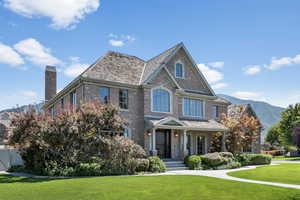 View of front of house featuring a mountain view and a front lawn