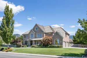 View of front of home featuring a garage and a front lawn