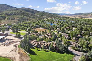 Drone / aerial view featuring a water and mountain view