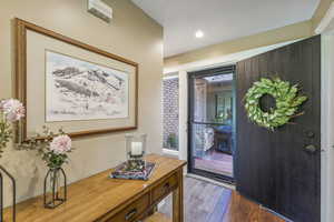 Entrance foyer featuring dark wood-type flooring and a textured ceiling