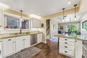 Kitchen featuring backsplash, hanging light fixtures, stainless steel appliances, and sink