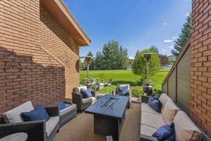 View of patio featuring an outdoor living space with a fire pit