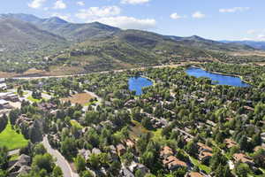 Drone / aerial view featuring a water and mountain view