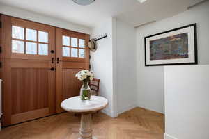 Entryway featuring light parquet floors and a wealth of natural light