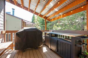 Wooden deck featuring a grill