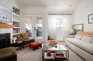 Carpeted living room featuring wooden ceiling, french doors, and built in shelves