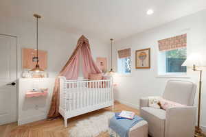 Bedroom featuring a crib and hardwood / wood-style floors