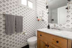 Bathroom with tile patterned floors, toilet, and vanity