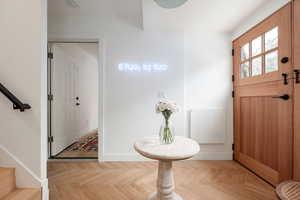 Entrance foyer featuring light parquet flooring