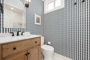 Bathroom with tile patterned flooring, vanity, and toilet