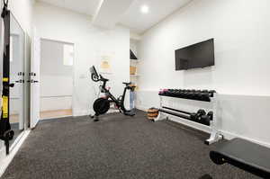 Exercise room featuring crown molding