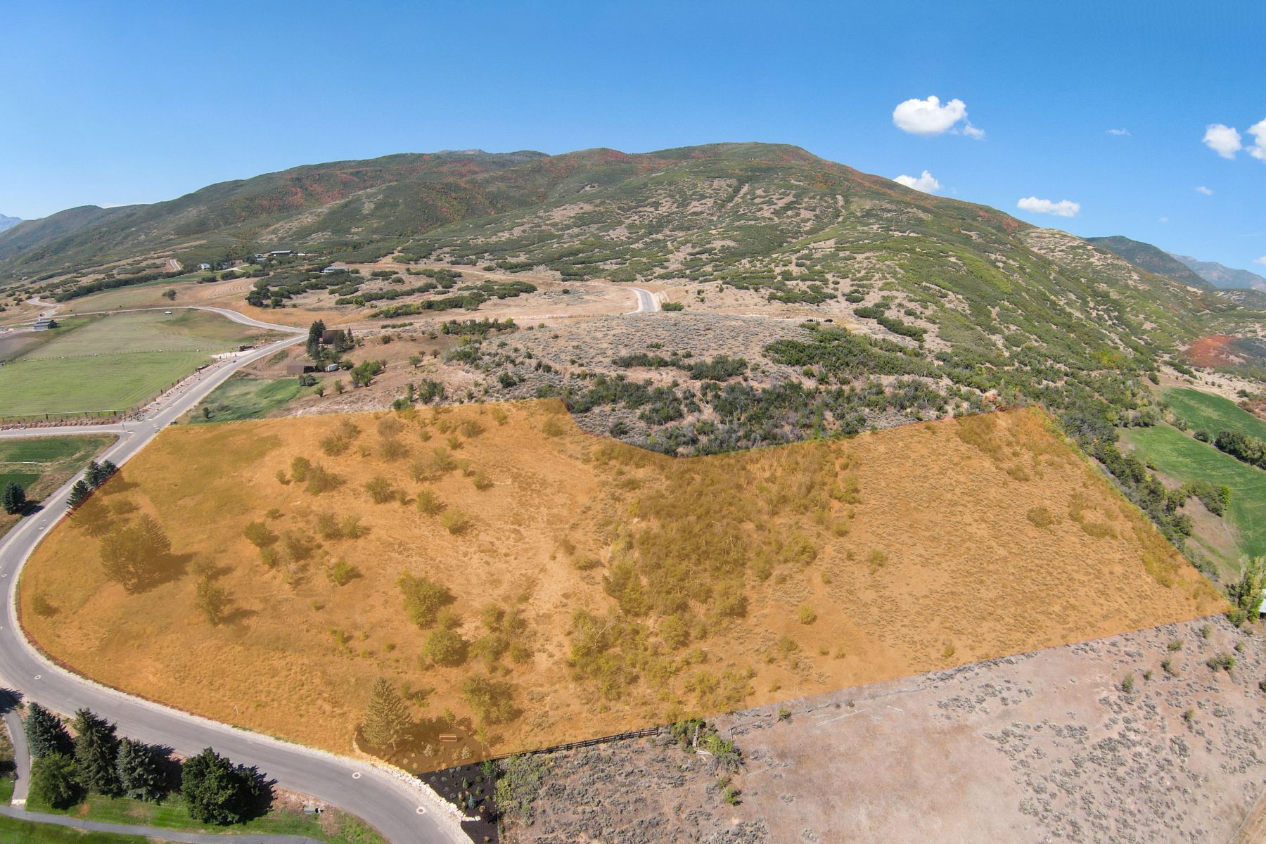 Expansive land parcel featuring natural terrain and varied vegetation