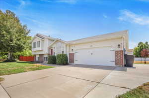 View of front of home featuring a front yard and a garage