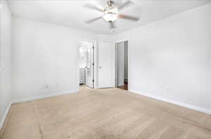 Carpeted spare room featuring ceiling fan