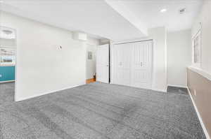 Unfurnished bedroom featuring a closet, electric panel, and carpet flooring