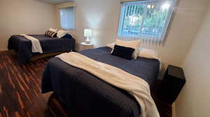 Bedroom with dark wood-type flooring