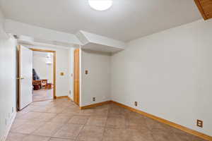 Empty room featuring light tile patterned flooring