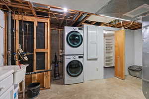 Basement with stacked washing maching and dryer