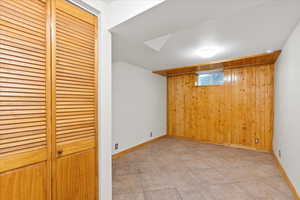 Interior space featuring light tile patterned floors and wooden walls