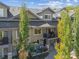 Rear view of property featuring a patio and a balcony