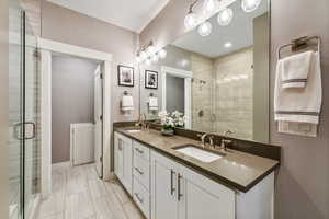 Bathroom featuring walk in shower and vanity