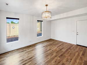 Spare room featuring hardwood / wood-style flooring and a healthy amount of sunlight