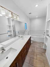 Full bathroom featuring vanity, toilet, plus walk in shower, and tile patterned floors