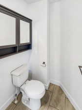 Bathroom featuring toilet and tile patterned floors