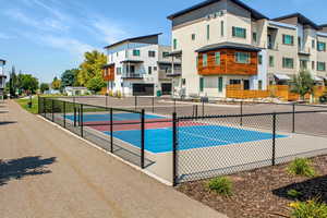 View of pool featuring tennis court