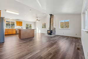 Unfurnished living room featuring hardwood / wood-style flooring, plenty of natural light, and vaulted ceiling