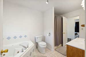 Full bathroom featuring vanity, toilet, independent shower and bath, and tile patterned floors