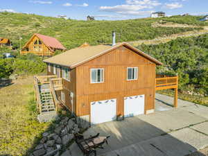 Exterior space with a garage and a deck