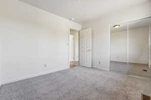 Unfurnished bedroom featuring a closet and carpet flooring