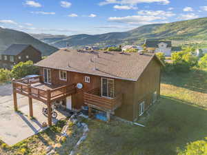 Exterior space with a patio area and a deck with mountain view