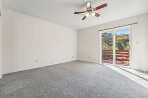 Unfurnished room with ceiling fan and carpet floors