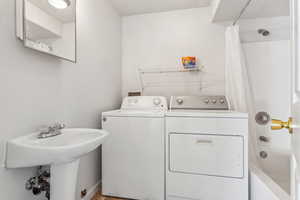 Washroom with washer and clothes dryer