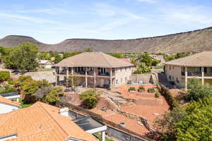 Rear view of property with a patio area, a mountain view, and a balcony