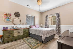 Bedroom with ceiling fan and light hardwood / wood-style flooring