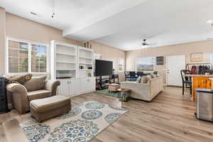 Living room featuring a wealth of natural light, ceiling fan, and light hardwood / wood-style floors