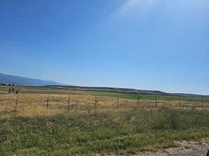 View of yard with a mountain view and a rural view