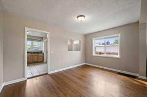 Spare room featuring a textured ceiling, light hardwood / wood-style flooring, and sink