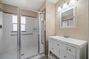 Bathroom with vanity and an enclosed shower