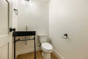 Bathroom featuring hardwood / wood-style floors and toilet. 2425 S.