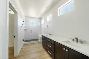 Owner's Bathroom featuring a shower with door, hardwood / wood-style flooring, and vanity. 2425 S.