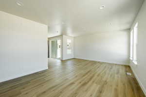 Living room featuring light hardwood / wood-style floors and a textured ceiling. 2425 S.