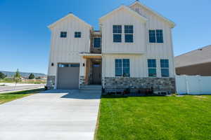 View of the front of the house with a garage and a front lawn. 2425 S.