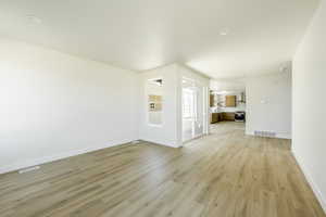 Unfurnished living room with light wood-type flooring. 2411 S.