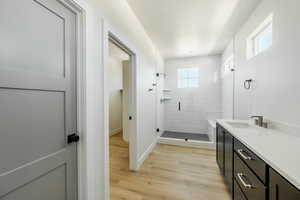 Owner's Bathroom features plenty of natural light, an enclosed shower, hardwood / wood-style flooring, and a vanity. 2425 S.