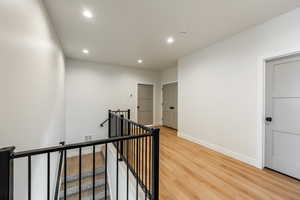 Corridor with light hardwood / wood-style floors. 2425 S.